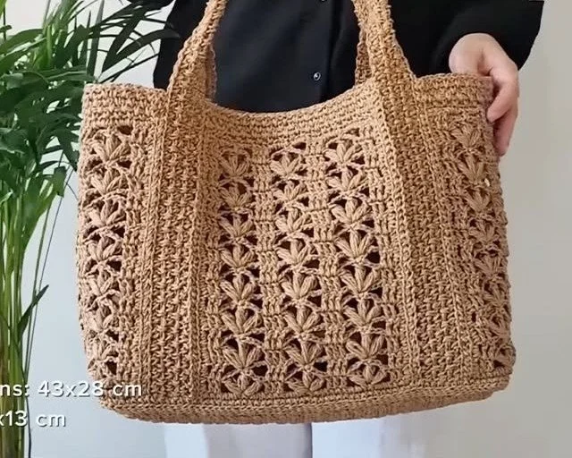 Stylish crochet tote bag displayed in a sunny outdoor setting